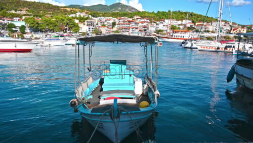 Video - NEOS MARMARAS, GREECE - OCTOBER 8, 2020: A moored boat made of wood in Aegean sea port, buildings on the background