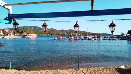 Video - Suspended street lights, moored sailboats and view of the town on the background, Neos Marmaras, Greece. Slow motion