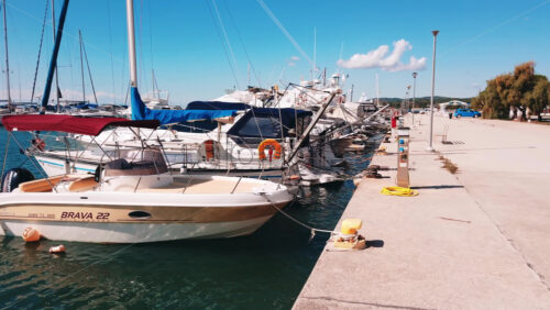 Video - NIKITI, GREECE - OCTOBER 8, 2020: Aegean sea port with multiple moored yachts and boats, clear weather. Slow motion