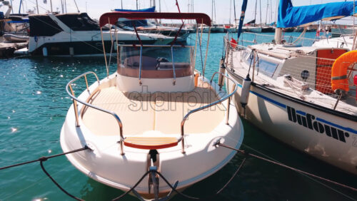 Video - NIKITI, GREECE - OCTOBER 8, 2020: Aegean sea port with multiple moored yachts and boats, clear weather. Slow motion