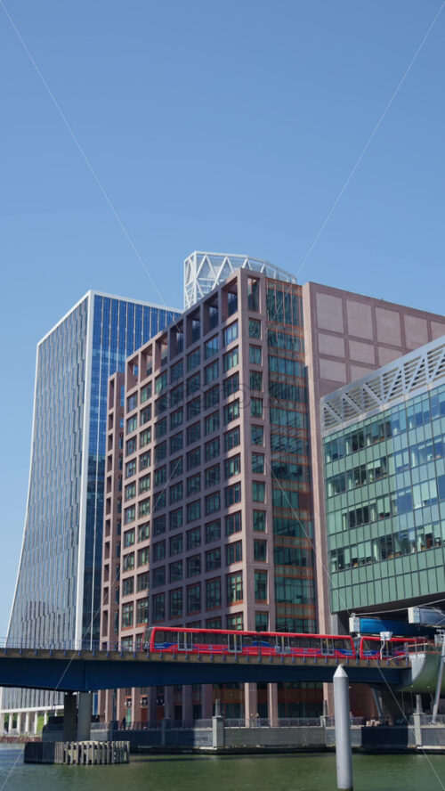 A Railway moving through Canary Wharf. Vertical, London, England - Starpik Stock