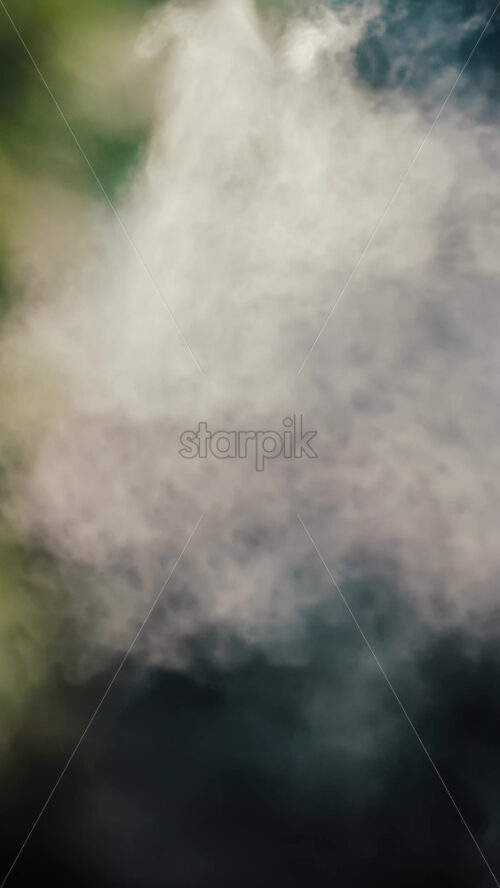 A jet of water spraying into the air against a dark background - Starpik Stock
