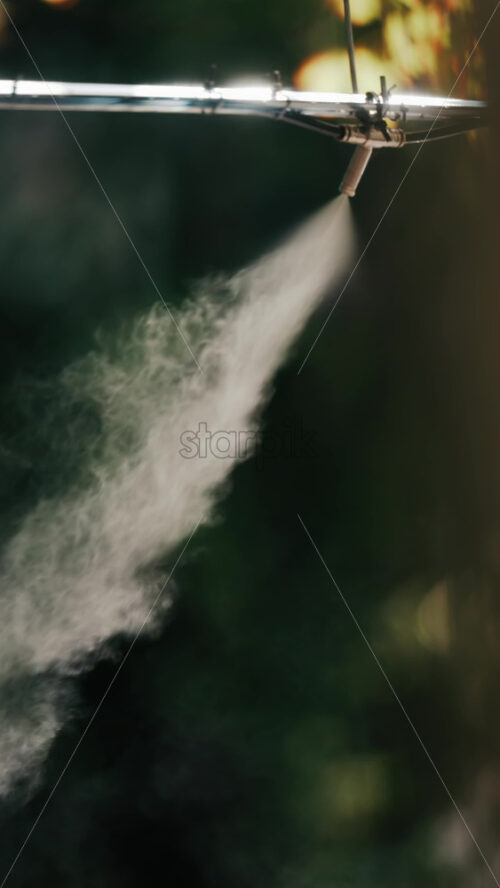 A jet of water spraying into the air against a dark background - Starpik Stock