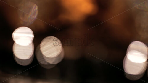 Abstract composition of light trails and overlapping bokeh in warm golden tones - Starpik Stock