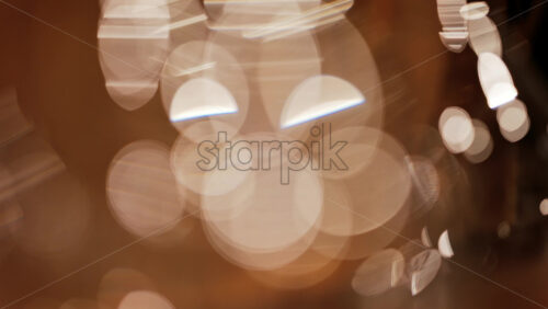 Abstract composition of light trails and overlapping bokeh in warm golden tones - Starpik Stock