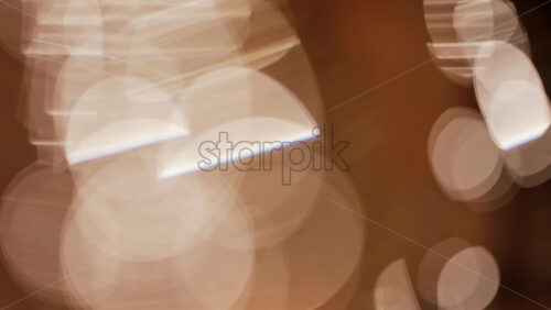 Abstract composition of light trails and overlapping bokeh in warm golden tones - Starpik Stock