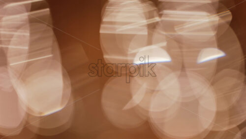 Abstract composition of light trails and overlapping bokeh in warm golden tones - Starpik Stock
