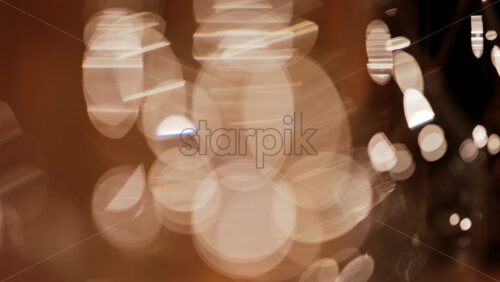 Abstract composition of light trails and overlapping bokeh in warm golden tones - Starpik Stock