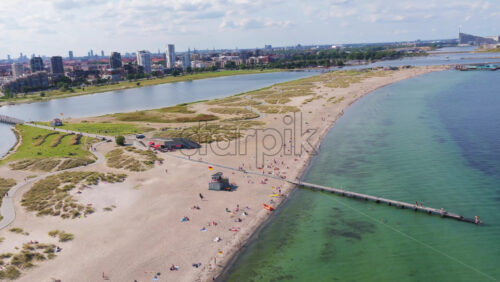 Aerial drone view of Amager Strandpark beach and dunes, with the Copenhagen skyline visible in the distance - Starpik Stock