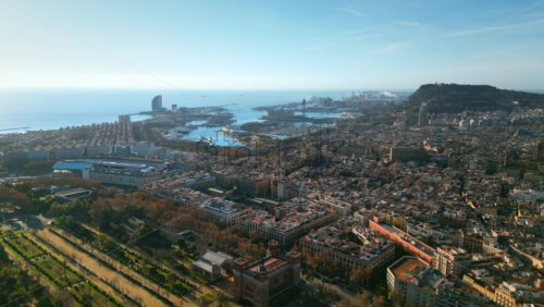 Aerial drone view of Barcelona, Spain, featuring Montjuic hill, the bustling Port of Barcelona, and the historic city center - Starpik Stock