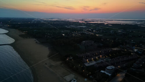 Aerial drone view of Cavallino-Treporti in the Venetian Lagoon in northern Italy in the evening - Starpik Stock