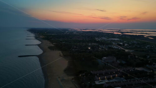 Aerial drone view of Cavallino-Treporti in the Venetian Lagoon in northern Italy in the evening - Starpik Stock