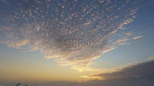 Aerial drone view of Copenhagen, Denmark at sunset with glowing skies, wind turbines in the background - Starpik Stock