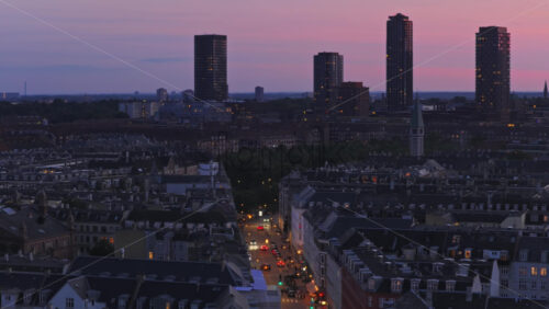Aerial drone view of Copenhagen’s skyline at twilight, featuring the Bispebjerg towers rising above the city - Starpik Stock