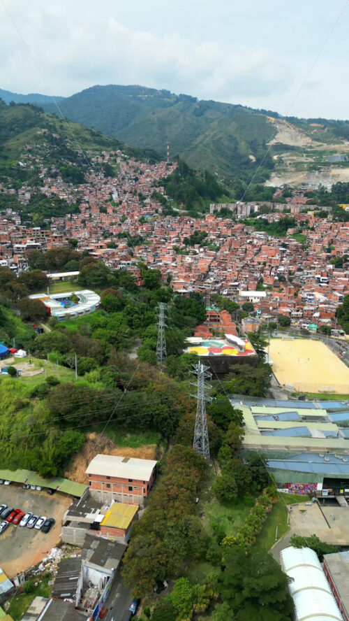 Aerial drone view of Medellin, historic hillside town in Colombia in daylight. Vertical - Starpik Stock