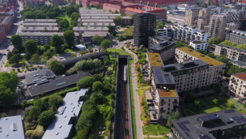 Aerial drone view of Oresund Metro Station and surrounding Amager apartments, showing modern high-rises and residential blocks - Starpik Stock