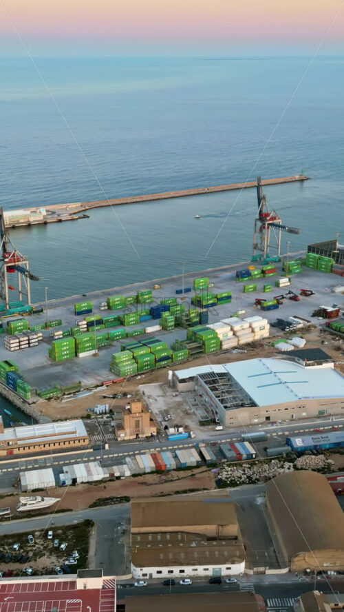 Aerial drone view of a Cargo terminal in Alicante, Spain at sunset. Vertical - Starpik Stock