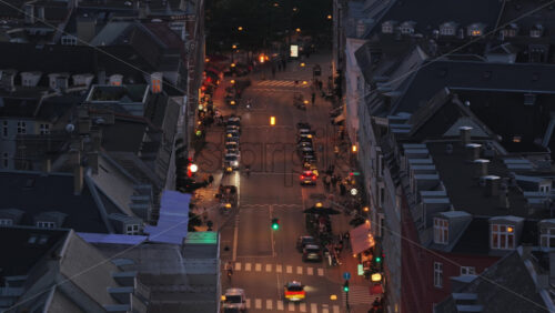 Aerial drone view of a lively street illuminated by cars, bicycles, and pedestrians in Norrebro - Starpik Stock