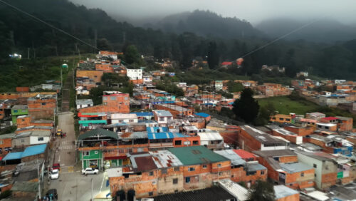 Aerial drone view of a low-income hillside neighbourhood in the outskirts of Bogota, Colombia - Starpik Stock