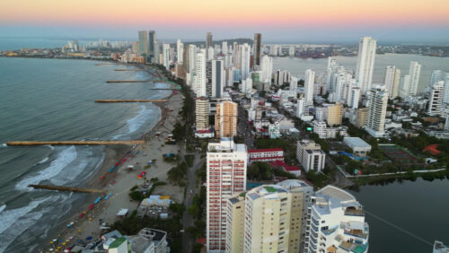 Aerial drone view of buildings alongside the Caribbean coastline in Cartagena, Colombia in the evening - Starpik Stock