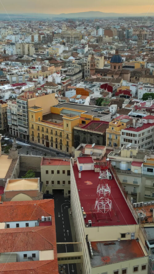 Aerial drone view of cars moving on the streets of Valencia, Spain in daylight. Vertical - Starpik Stock
