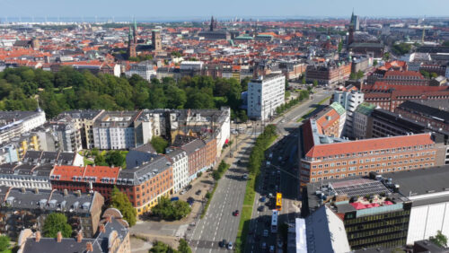Aerial drone view of central Copenhagen, Denmark featuring Orstedsparken, historic churches, and orange rooftops - Starpik Stock