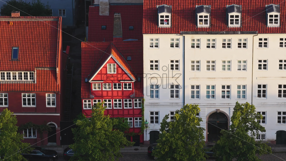 Aerial drone view of colourful historic houses with red rooftops in Copenhagen, Denmark - Starpik Stock