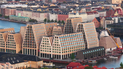Aerial drone view of modern waterfront architecture at Papiroen mixed-use development in Copenhagen, Denmark - Starpik Stock