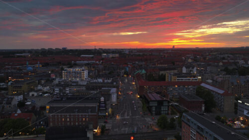Aerial drone view of of Norrebro rooftops and streets during sunset, with dramatic golden sky over Copenhagen, Denmark - Starpik Stock
