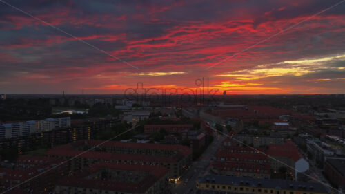 Aerial drone view of of Norrebro rooftops and streets during sunset, with dramatic golden sky over Copenhagen, Denmark - Starpik Stock