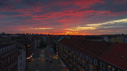Aerial drone view of of Norrebro rooftops and streets during sunset, with dramatic golden sky over Copenhagen, Denmark - Starpik Stock