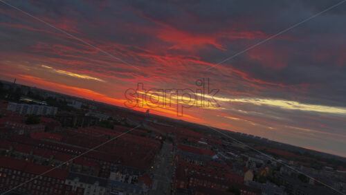 Aerial drone view of of Norrebro rooftops and streets during sunset, with dramatic golden sky over Copenhagen, Denmark - Starpik Stock