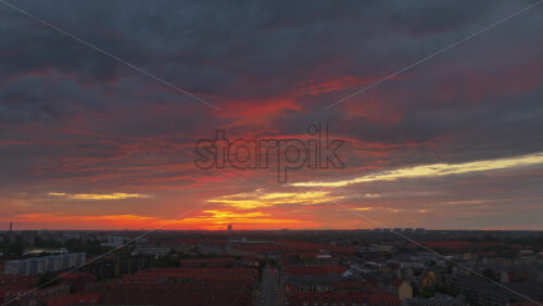 Aerial drone view of of Norrebro rooftops and streets during sunset, with dramatic golden sky over Copenhagen, Denmark - Starpik Stock