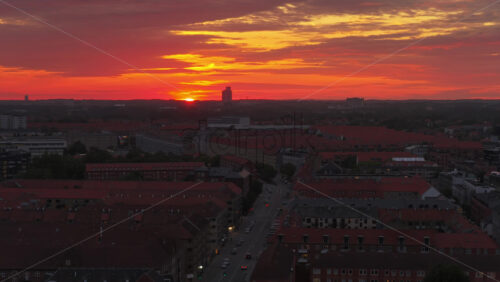 Aerial drone view of of Norrebro rooftops and streets during sunset, with dramatic golden sky over Copenhagen, Denmark - Starpik Stock