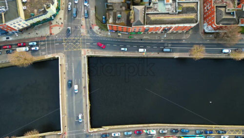 Aerial drone view of the Grand Canal Dock, Dublin featuring modern buildings, waterfront apartments, and green buses - Starpik Stock