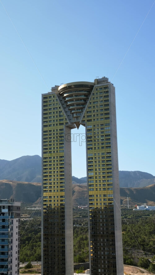 Aerial drone view of the Intempo skyscraper building in Benidorm, Alicante, Spain in daylight. Vertical - Starpik Stock