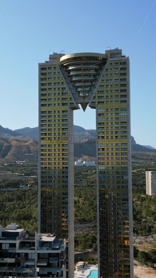 Aerial drone view of the Intempo skyscraper building in Benidorm, Alicante, Spain in daylight. Vertical - Starpik Stock