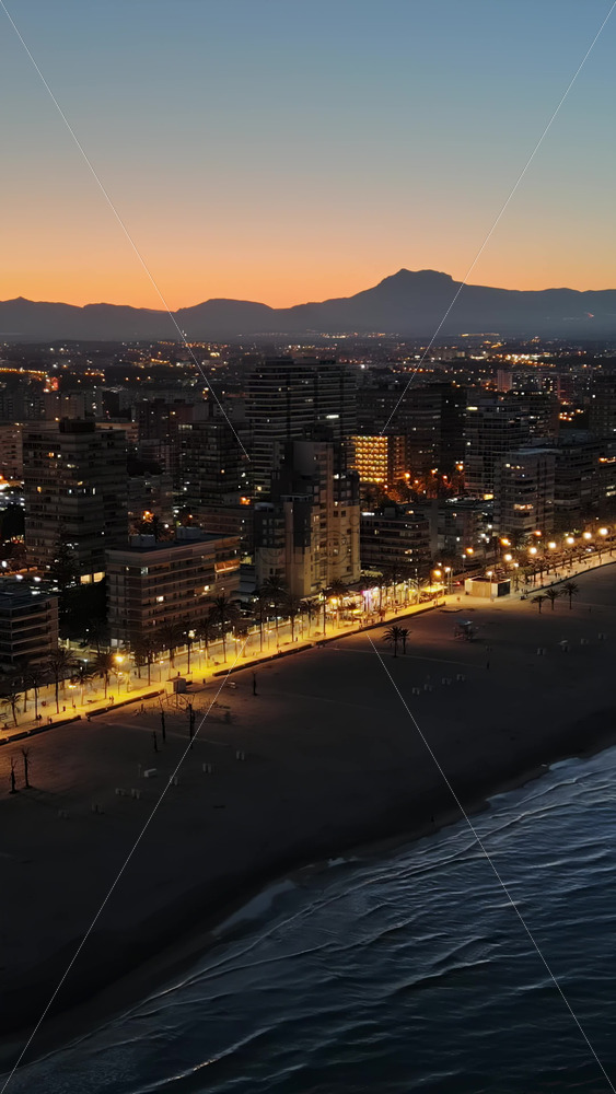 Aerial drone view of the Mediterranean Sea and the Alicante city in Spain at sunset. Vertical - Starpik Stock