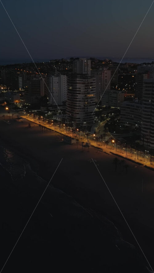 Aerial drone view of the Mediterranean Sea and the Alicante city in Spain at sunset. Vertical - Starpik Stock