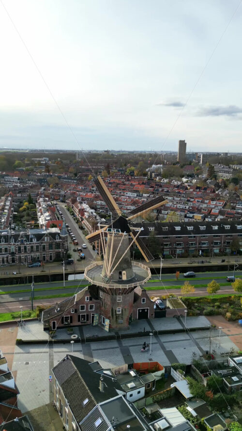 Aerial drone view of the Molen De Roos, historic windmill in Delft, Netherlands. Vertical - Starpik Stock
