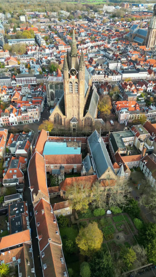 Aerial drone view of the Nieuwe Kerk Protestant church in the city of Delft in the Netherlands. Vertical - Starpik Stock