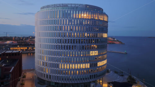 Aerial drone view of the Nordo office building illuminated in the evening in Copenhagen, Drone - Starpik Stock