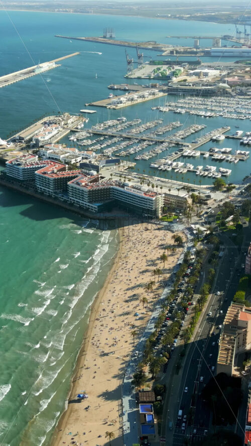 Aerial drone view of the Port of Alicante and the buildings in the city in daylight. Vertical - Starpik Stock