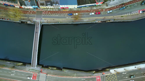 Aerial drone view of the River Liffey in Dublin, showing bus lanes, and riverside buildings - Starpik Stock