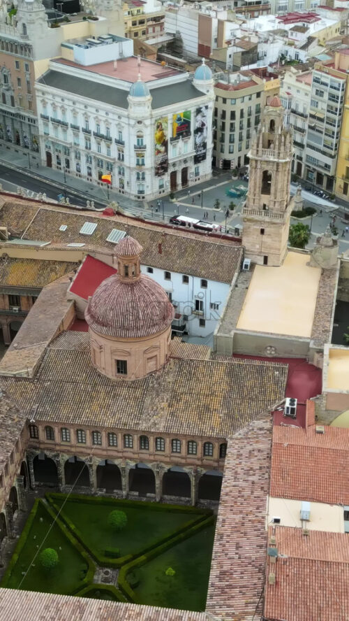 Aerial drone view of the Santa Catalina Church surrounded by buildings in Valencia, Spain. Vertical - Starpik Stock