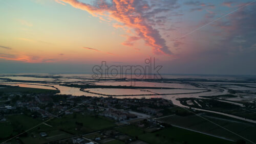 Aerial drone view of the Venetian Lagoon at sunset, near Cavallino-Treporti in northern Italy - Starpik Stock