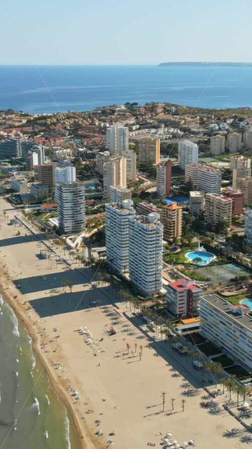 Aerial drone view of the buildings in Benidorm, Spain in daylight. Vertical - Starpik Stock