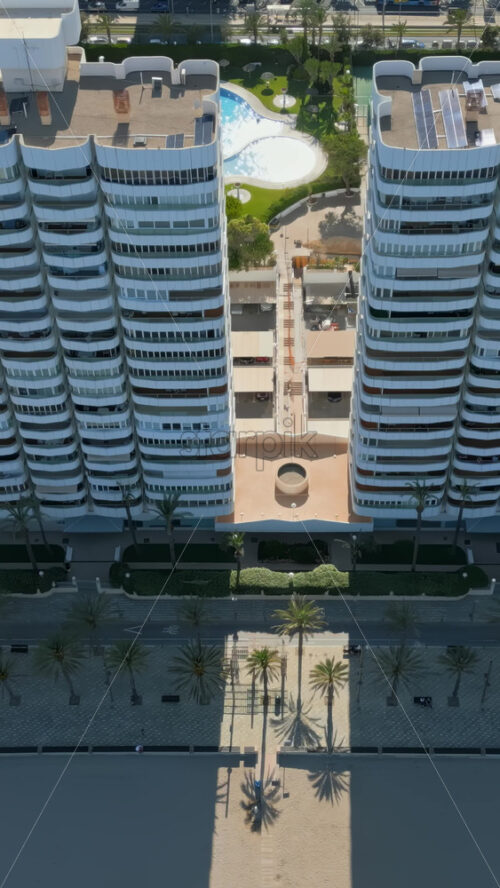 Aerial drone view of the buildings in Benidorm, Spain in daylight. Vertical - Starpik Stock