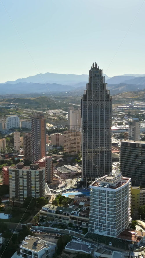 Aerial drone view of the buildings in Benidorm, Spain in daylight. Vertical - Starpik Stock