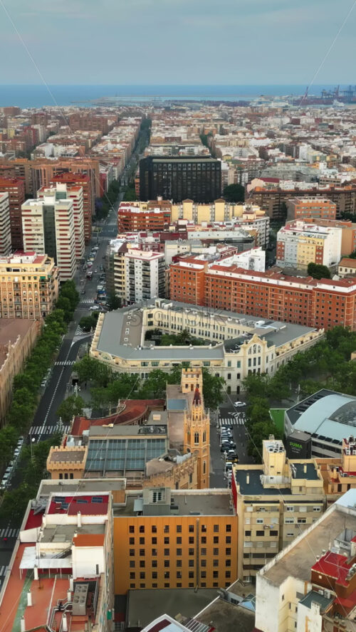 Aerial drone view of the buildings in Valencia, Spain in daylight. Vertical - Starpik Stock
